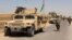 FILE - Afghan National Army (ANA) troops arrive in Nad Ali district of Helmand province, southern Afghanistan, Aug. 10, 2016.