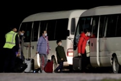 Australian evacuees from China's Wuhan city board a bus after arriving at the airport on Christmas Island, Australia, Feb. 6, 2020.