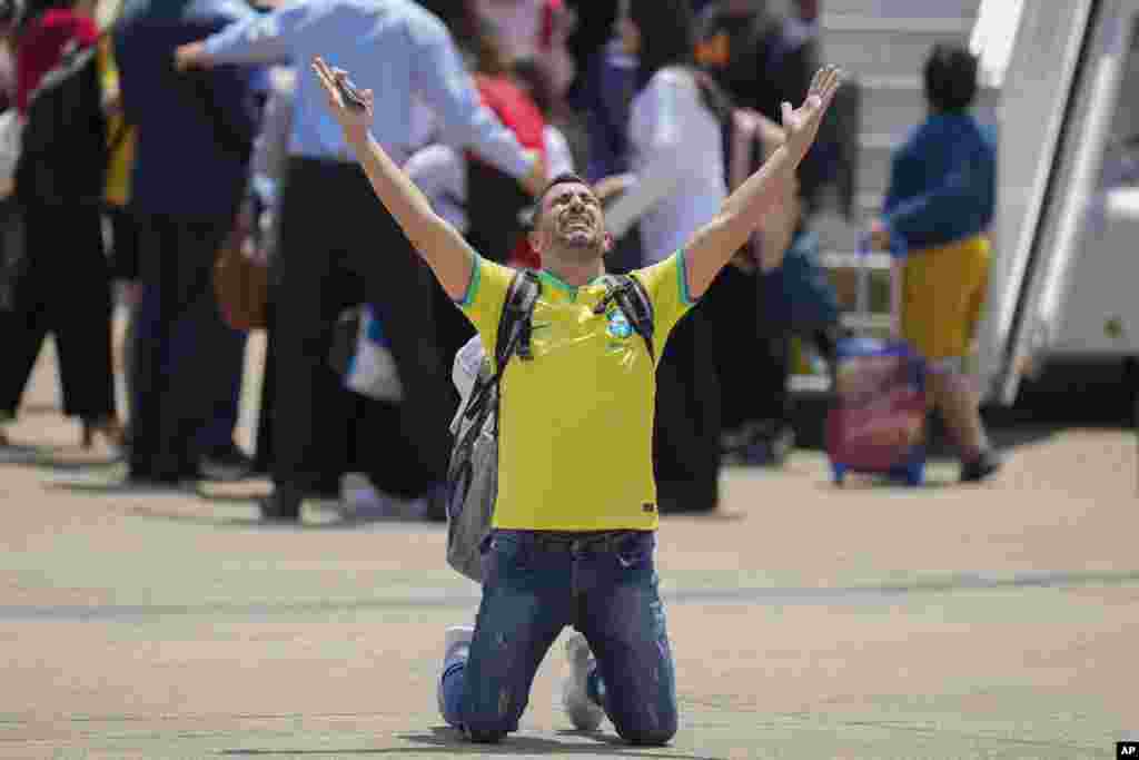 A Brazilian reacts after the Air Force evacuated him from Lebanon amid Israeli airstrikes, at the Air Force base in Guarulhos, greater Sao Paulo area.