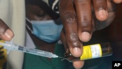 FILE—A nurse prepares to administer yellow fever vaccine at Kiswa Health Center III in Kampala, Uganda, April 2, 2024.