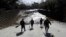 Members of the Los Angeles County Fire Department Search and Rescue crew walk toward flooded waters in Montecito, Calif., Jan. 10, 2018. 