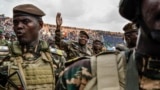 TOPSHOT - General Abdourahamane Tiani (C), the head of the military regime in Niger, greets the thousands of people who gathered at the largest stadium in Niamey for the launch of festivities marking the first anniversary of his coming to power after the 