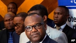 FILE - Corneille Nangaa, the president of the independent electoral commission (CENI), announces the postponement of the elections, in Kinshasa, Democratic Republic of the Congo, December 20, 2018. 