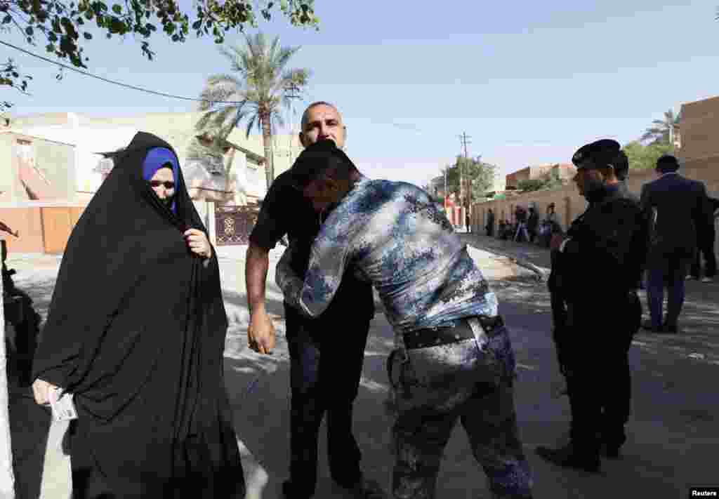 An Iraqi security forces member checks people at a polling station during a parliamentary election in Baghdad April 30, 2014. Iraqis headed to the polls on Wednesday in their first national election since U.S. forces withdrew from Iraq in 2011, with Prime