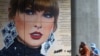 People view mural of Taylor Swift next to Wembley Stadium, as they attend Community Shield football match, at Wembley Stadium in London