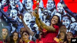 FILE - Spain's Jenni Hermoso holds the trophy as the team celebrates its Women's World Cup victory in Madrid on Aug. 21, 2023. The Spanish prosecutor's office announced on Sept. 6, 2023, that Hermoso has formally accused Luis Rubiales of sexual assault.