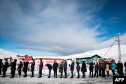 FILE - Voters stand in line to cast their ballots for a parliamentary election at a polling station in Greenland's capital, Nuuk, on April 6, 2021. Greenland is due to hold a another general election by April 2025 at the latest.