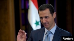 FILE - Syria's President Bashar al-Assad is seen during the filming of an interview with the BBC, in Damascus, Feb. 9, 2015.