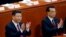 Chinese President Xi Jinping, left, and Chinese Premier Li Keqiang applaud during the opening session of the annual National People's Congress at the Great Hall of the People in Beijing, March 5, 2018.