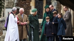 Britain's King Charles speaks with Reverend Canon Dr Paul Williams, as Queen Camilla, Britain's William, Prince of Wales, Catherine, Princess of Wales, and other family members leave St. Mary Magdalene's church, on the Sandringham estate, Dec. 25, 2024.