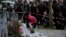 A girl lays flowers as part of a memorial to victims of the terror attacks in Paris, France, Nov. 14, 2015.