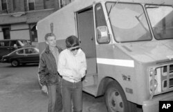 FILE - Rosie Ruiz, who was accused of cutting corners to win the Boston Marathon two years ago, leaves Central Booking at Police Headquarters in New York, April 20, 1982, where she was charged with stealing $60,000 from the firm where she worked.
