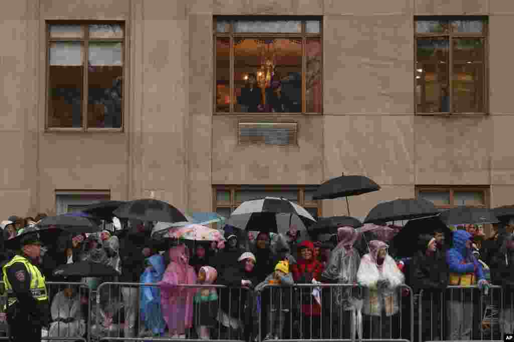 Spectators ticker  successful  the rainfall  arsenic  the Macy's Thanksgiving Day Parade travels down   Central Park West, Nov. 28, 2024, successful  New York. 