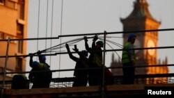 Laborers work at a construction site in Warsaw, Nov. 5, 2014.