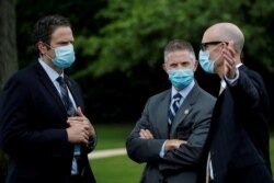 FILE - U.S. Secret Service agents gather for coronavirus tests prior to President Donald Trump's departure for the Kennedy Space Center in Florida, May 27, 2020.