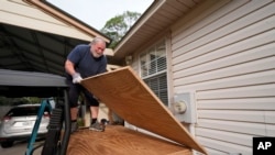 Dave McCurley boards up the windows to his home in advance of Tropical Storm Helene, expected to make landfall as a hurricane, in Ochlockonee Bay, Florida, Sept. 25, 2024.