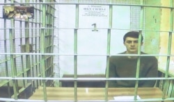 FILE - Student and blogger Yegor Zhukov, detained during a protest for fair elections, is seen on a screen via a video link during a court hearing in Moscow, Aug. 15, 2019.