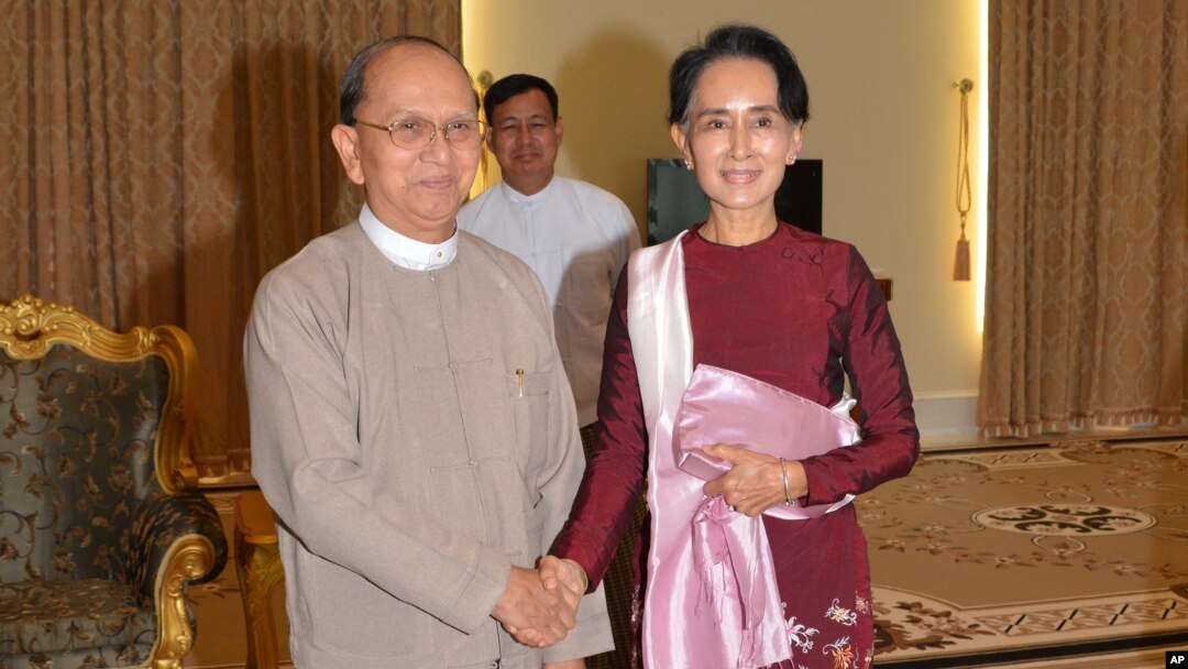 In this image provided by the Myanmar Ministry of Information, Myanmar President Thein Sein, left, shakes hands with opposition leader Aung San Suu Kyi during their meeting at the presidential in Naypyitaw, Myanmar, Dec. 2, 2015.