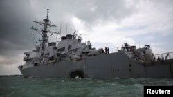 FILE - The U.S. Navy guided-missile destroyer USS John S. McCain is seen after a collision in Singapore waters, Aug. 21, 2017.