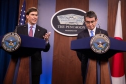 FILE - Defense Secretary Mark Esper and Japan's Defense Minister Taro Kono speak during a news conference at the Pentagon in Washington, Jan. 14, 2020.