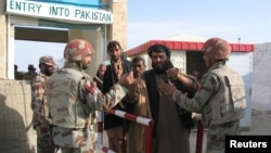 Pakistani soldiers check the identity of citizens returning from Afghanistan at the border town of Chaman, Pakistan, March 7, 2017. 