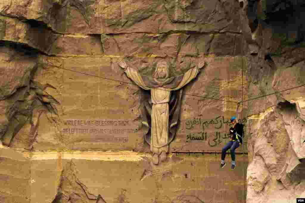 Visitors zipline at a church site in the hills near Cairo, Jan. 6, 2021. After a 70% drop in Egypt’s tourism revenue in 2020, officials focused the year on rebuilding the industry. (Hamada Elrasam/VOA)