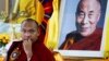 FILE - Tibetan spiritual leader Ogyen Trinley Dorje, the 17th Karmapa, looks on as he sits in front of a portrait of the Dalai Lama during a function commemorating the 50th anniversary of the Tibetan Institute of Medicine and Astrology in Dharmsala, India, June 2, 2011. 