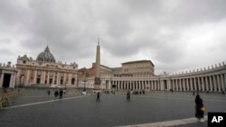 FILE - Few tourists walk in St. Peter's Square at the Vatican, March 6, 2020, the same day on which a Vatican spokesman confirmed the first case of coronavirus at the city-state.