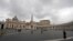 FILE - Few tourists walk in St. Peter's Square at the Vatican, March 6, 2020, the same day on which a Vatican spokesman confirmed the first case of coronavirus at the city-state.