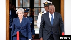 Britain's Prime Minister Theresa May and Kenya's President Uhuru Kenyatta arrive to address a joint news conference at the State House in Nairobi, Kenya, Aug. 30, 2018.