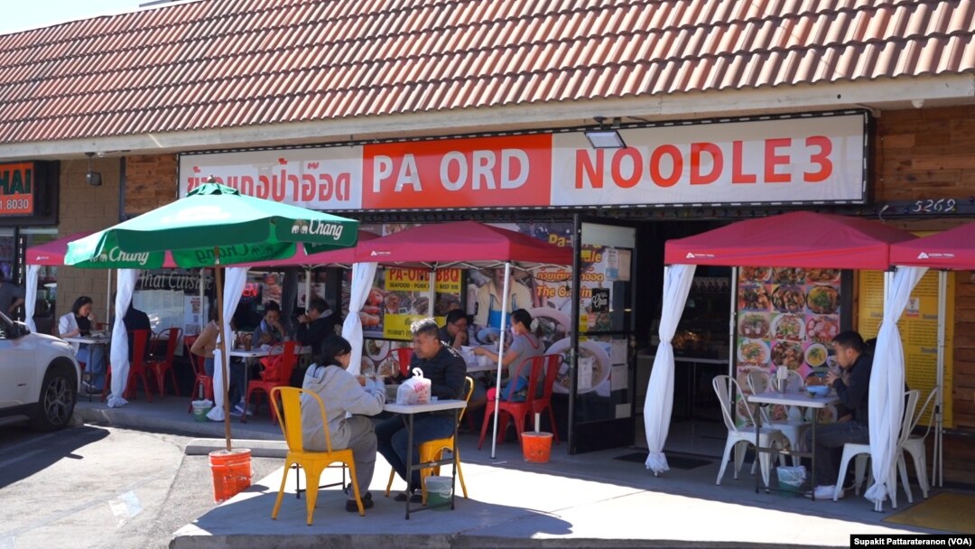 People eat at the tables outside Pa Ord Noodle 3, a Thai restaurant during the coronavirus disease (COVID-19) pandemic in Los Angeles, CA. Sept 2021.