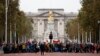 Climate protestors block the Mall leading to Buckingham Palace, rear, central London, Oct. 7, 2019.