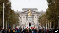 Climate protestors block the Mall leading to Buckingham Palace, rear, central London, Oct. 7, 2019.