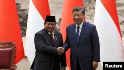 Chinese President Xi Jinping and Indonesian President Prabowo Subianto shake hands during a signing ceremony at the Great Hall of the People in Beijing, Nov. 9, 2024.