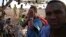 FILE - An illegal immigrant from Ethiopia covers his face as he waits with others for a boat to cross into Yemen outside the town of Obock, north Djibouti. 