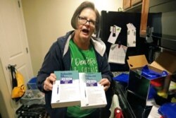 FILE - Ann Lovell holds her prescriptions at her home in South Jordan, Utah, following her visit to Tijuana, Mexico, Jan. 31, 2020. She travels every few months to Tijuana to buy medication for rheumatoid arthritis at a steep discount.