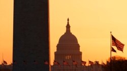 The Washington Monument and the U.S. Capitol are seen in Washington, at sunrise Wednesday, March 18, 2020. The White House has sent Congress an emergency $46 billion spending request for coronavirus-related funding this year. (AP Photo/Carolyn…