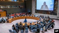 Philippe Lazzarini, Commissioner-General of the United Nations Relief and Works Agency for Palestine Refugees in the Near East is seen on a screen as he speaks to members of the U.N. Security Council at United Nations headquarters in New York, Oct. 30, 2023. 