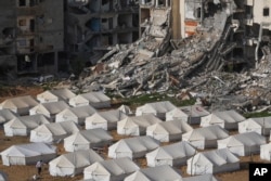 A tent camp for displaced Palestinians is set up next to destroyed buildings following the Israeli air and ground offensive in Jabaliya, Gaza Strip, Feb. 6, 2025.