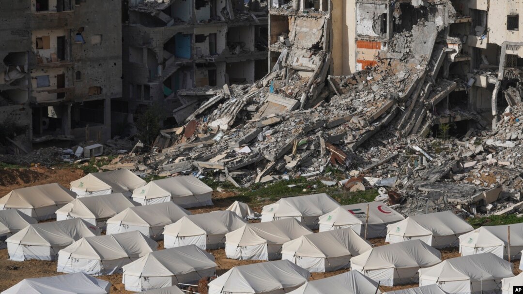 A tent camp for displaced Palestinians is set up next to destroyed buildings following the Israeli air and ground offensive in Jabaliya, Gaza Strip, Feb. 6, 2025.