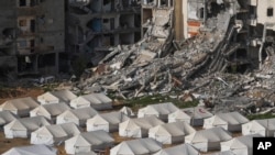 A tent camp for displaced Palestinians is set up next to destroyed buildings following the Israeli air and ground offensive in Jabaliya, Gaza Strip, Feb. 6, 2025.