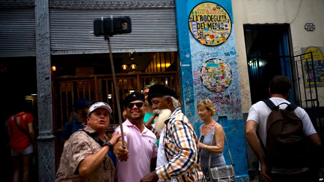 FILE - Tourists take a selfie at the Bodeguita del Medio bar in Havana, Cuba, April 28, 2017.