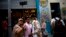 FILE - In this April 28, 2017,photo, tourists take a selfie at the Bodeguita Del Medio bar in Havana, Cuba.