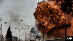 FILE - Fire and smoke billow following a car bomb explosion as Iraqi forces clash with Islamic State (IS) group fighters in Mosul on March 5, 2017.