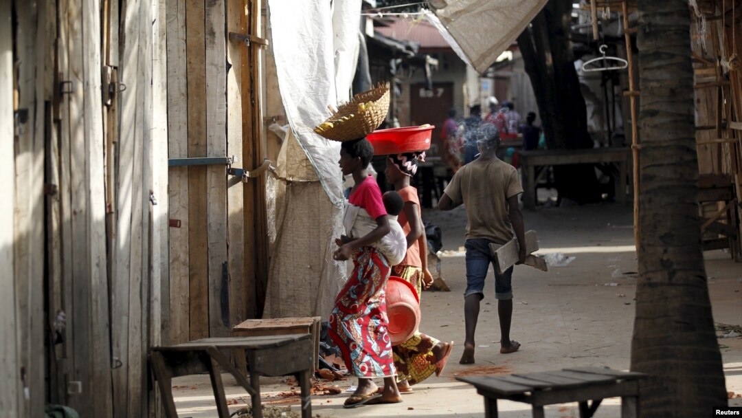 FILE - Women walk through a market deserted following protests in Bujumbura, April 29, 2015. 