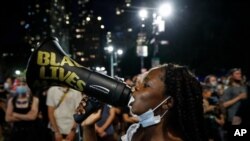 FILE - Protesters gather at an encampment outside City Hall in New York, June 30, 2020. Black activists from across the U.S. will hold the 2020 Black National Convention on Aug. 28, 2020, via livestream to produce a new political agenda.