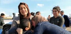 FILE - Relatives hug a Yazidi survivor boy following his release from IS militants in Syria, in Duhok, Iraq, March 2, 2019.
