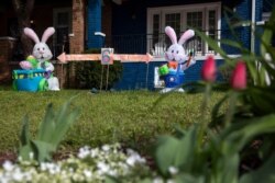 The owners of a house known for their seasonal decorations have put up a display combining Easter and coronavirus-related social distancing measures in their yard, seen April 1, 2020, in Washington, D.C.