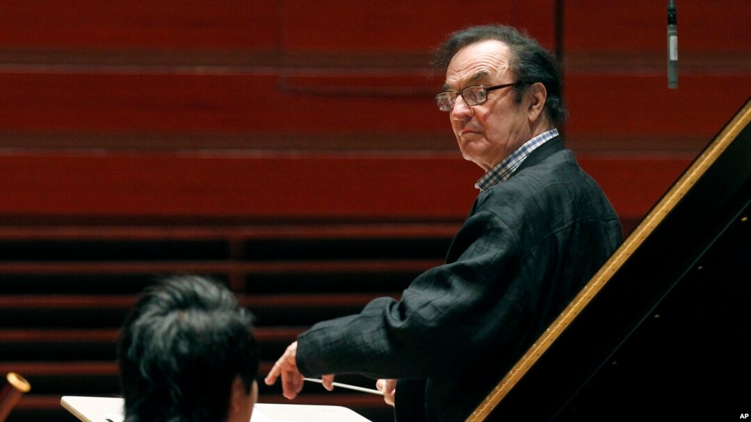 FILE - In this Oct. 19, 2011 file photo, world-renowned conductor Charles Dutoit, right, performs with the Philadelphia Orchestra. 