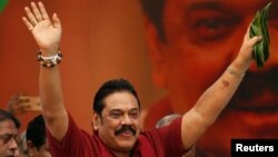 Sri Lanka's former president Mahinda Rajapaksa waves at his supporters as he arrives at a protest rally to launch a plan to topple the current government, accusing it of failing in its "management and development of the country" in Colombo, Sri Lanka, Jan. 27, 2017.